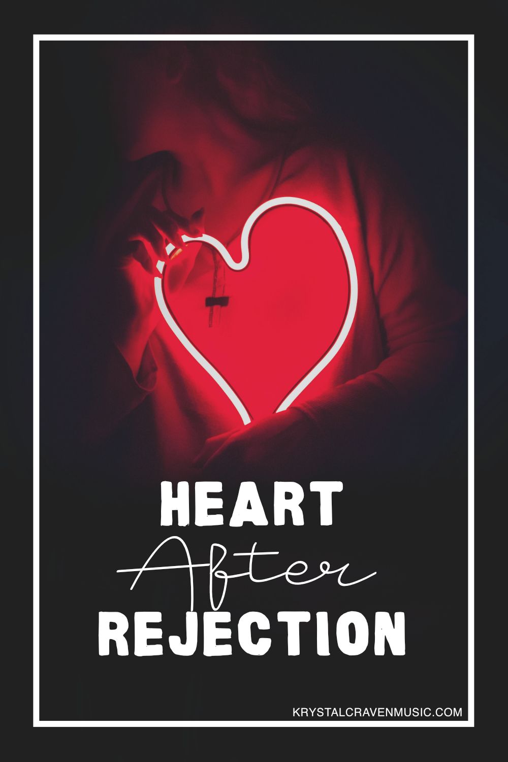 The title text "Heart After Rejection" in a large white font overlaying a woman in a dark room holding a large neon red heart.