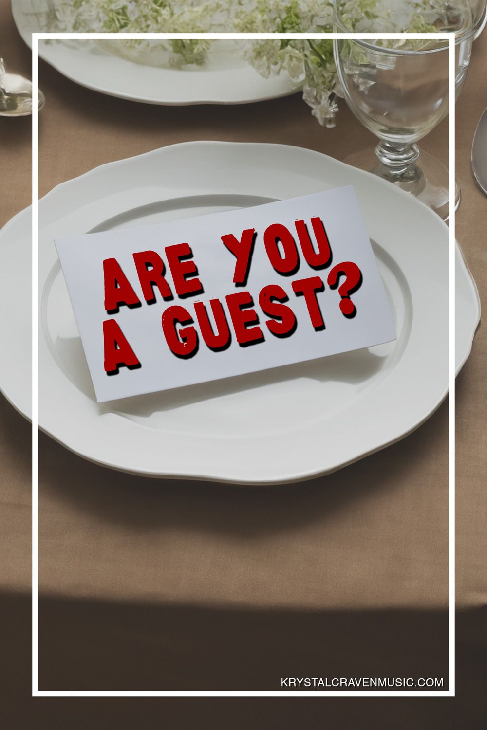 The title text "Are you a guest?" on a card set on a plate at a formal plate setting.