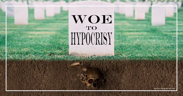 A white washed tombstone with the devotional title "Woe to Hypocrisy" on it. The grass fades into dirt on the lower half of the image with a skull and bones underneath the tombstone in the dirt. 