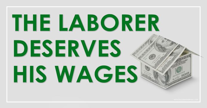 The title text "The Laborer Deserves His Wages" in a large green font overlaid on a paper house made out of five $100 bills.