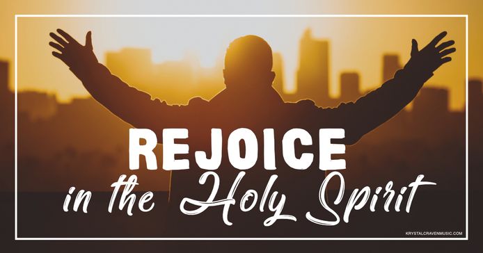The title text "Rejoice in the Holy Spirit" over the back of the silhouette of a man with his arms raised with a city skyline in the background with the sun just over the skyscrapers.