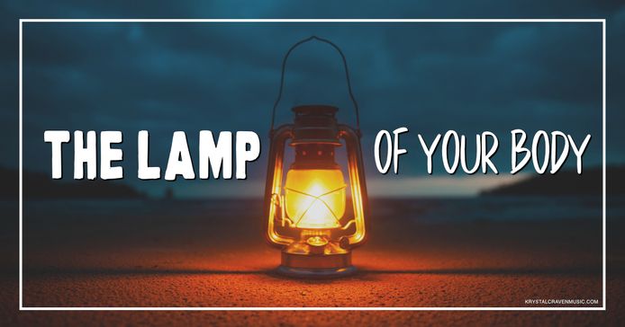 The title text "The Lamp of Your Body" overlaying a lit lamp at dusk on a beach.