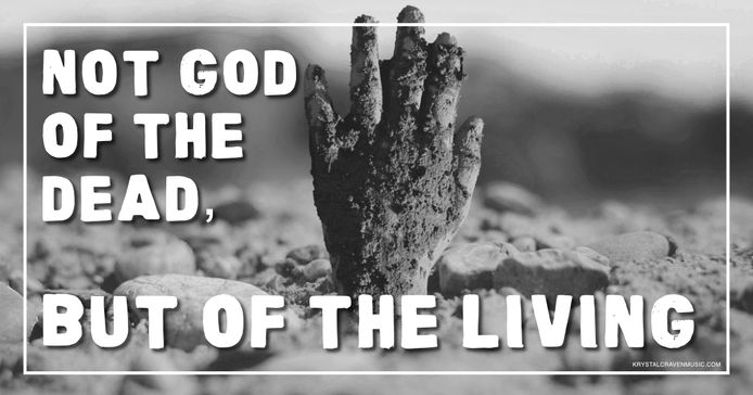 A mud covered hand emerging from the ground with the words "Not God of the Dead, But of the Living" overlaying the image