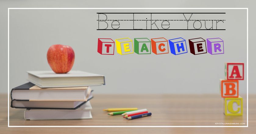 The devotional title text in dotted school font and block font overlaying a desk with these items on it: an apple on school books, colored pencils, and ABC blocks.