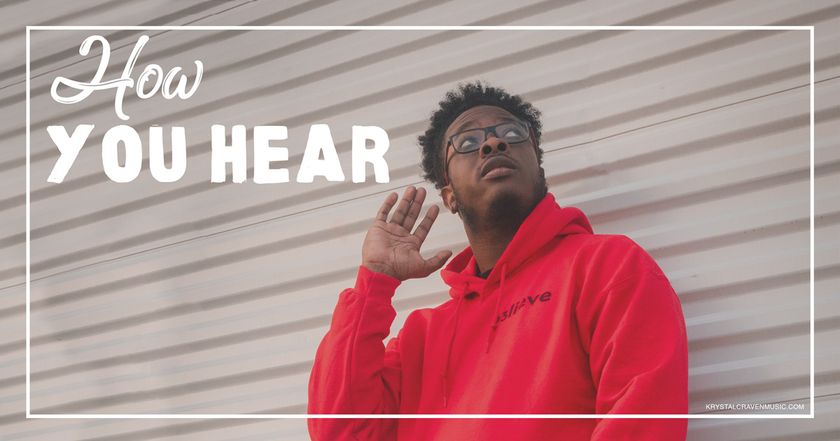 Devotional title text "How You Hear" overlaying a man in a red hoodie sweatshirt holding his hand up to his ear while looking up.