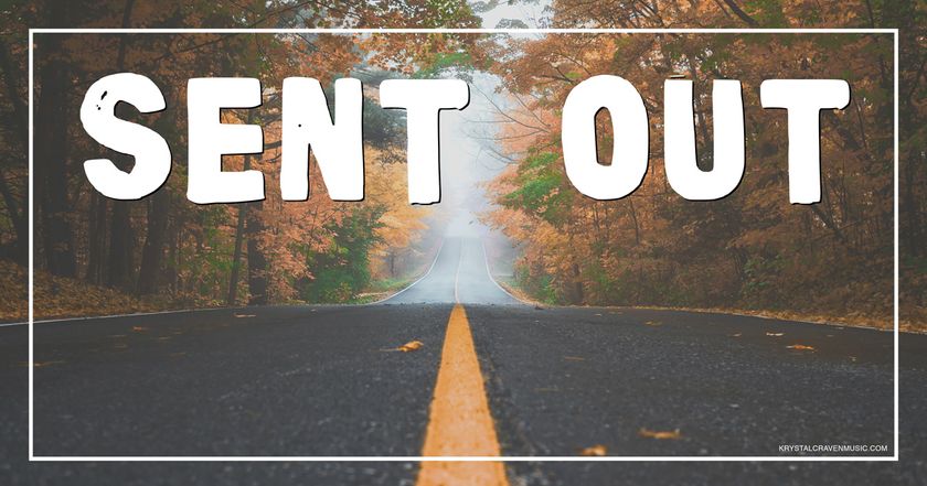 The devotional title text of "Sent Out" overlaying a road with the yellow line down the center. There are trees lining the road on either side with fall foliage, and the end of the road has fog covering it in the distance.