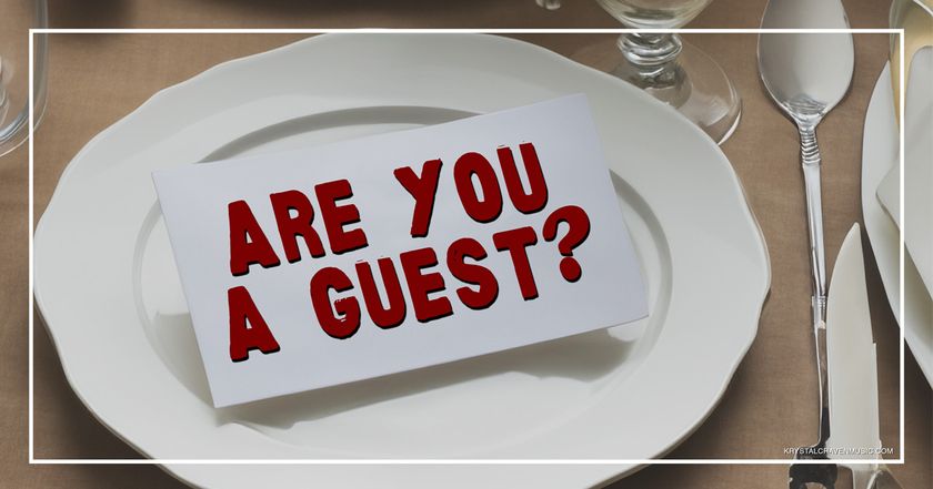 The title text "Are you a guest?" on a card set on a plate at a formal plate setting.